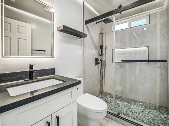 Custom Bright hallway bath with recess lighting.  Modern mirror w/lites & defogger.