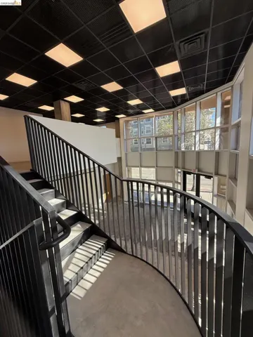 Staircase with concrete flooring and a drop ceiling