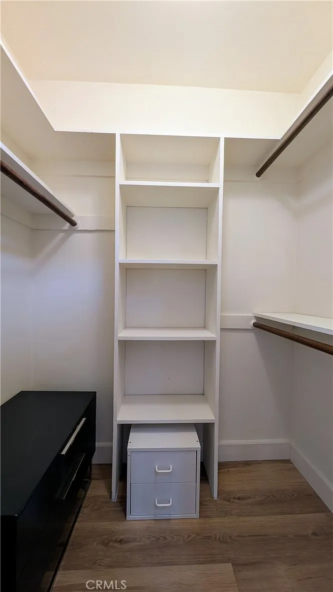 Primary bedroom walk-in closet Primary bedroom walk-in closet