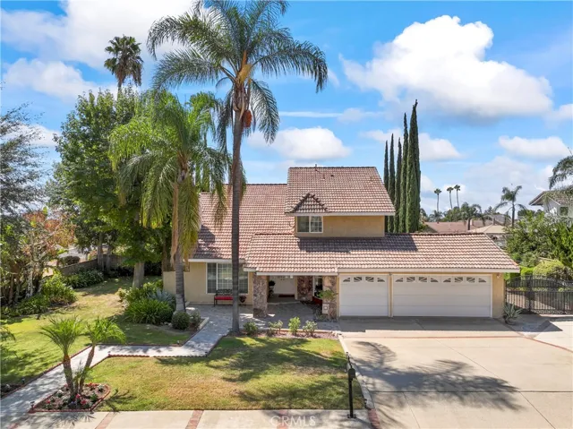 Street View of Home with mature trees, tile roof, 3 car garage and gated RV Parking
