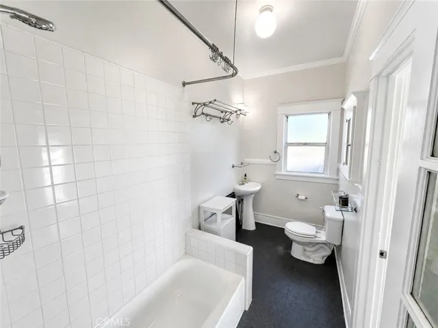 Bathroom with Reglazed tub, shower, pedestal sink and Storage.