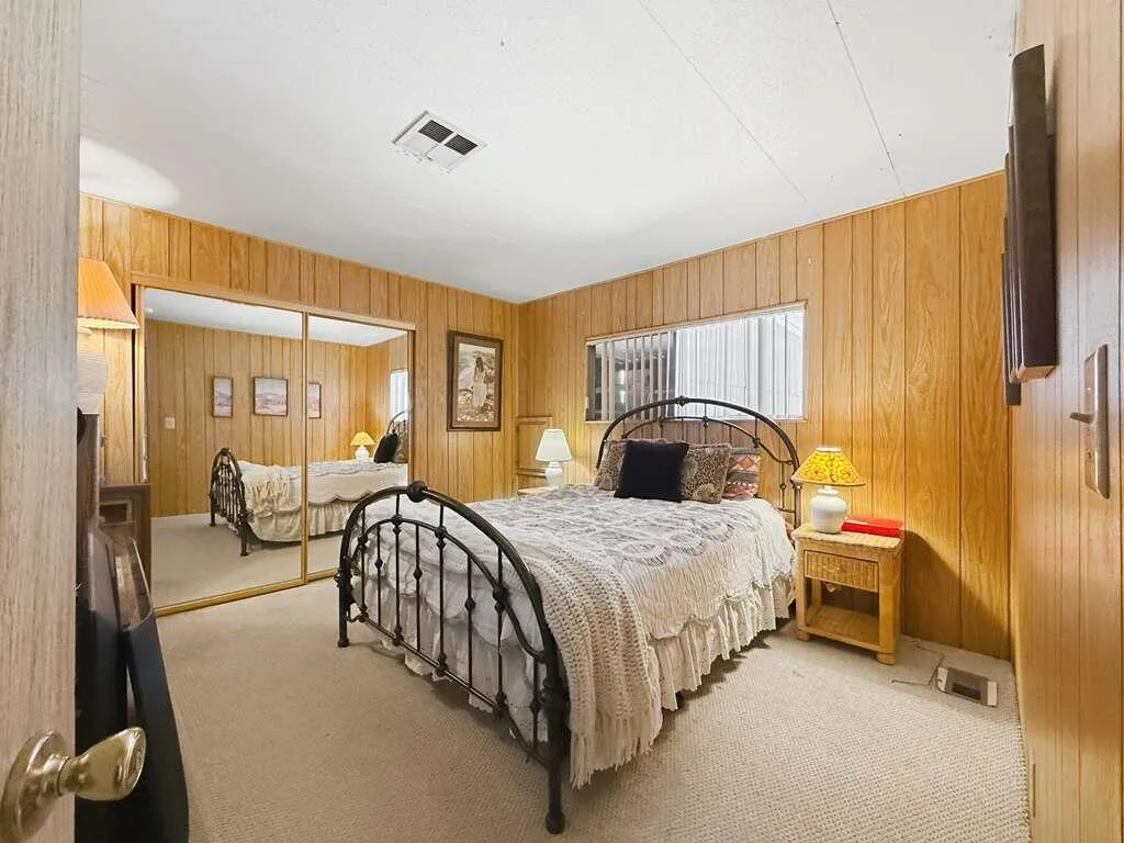 Guest bedroom with mirrored closet