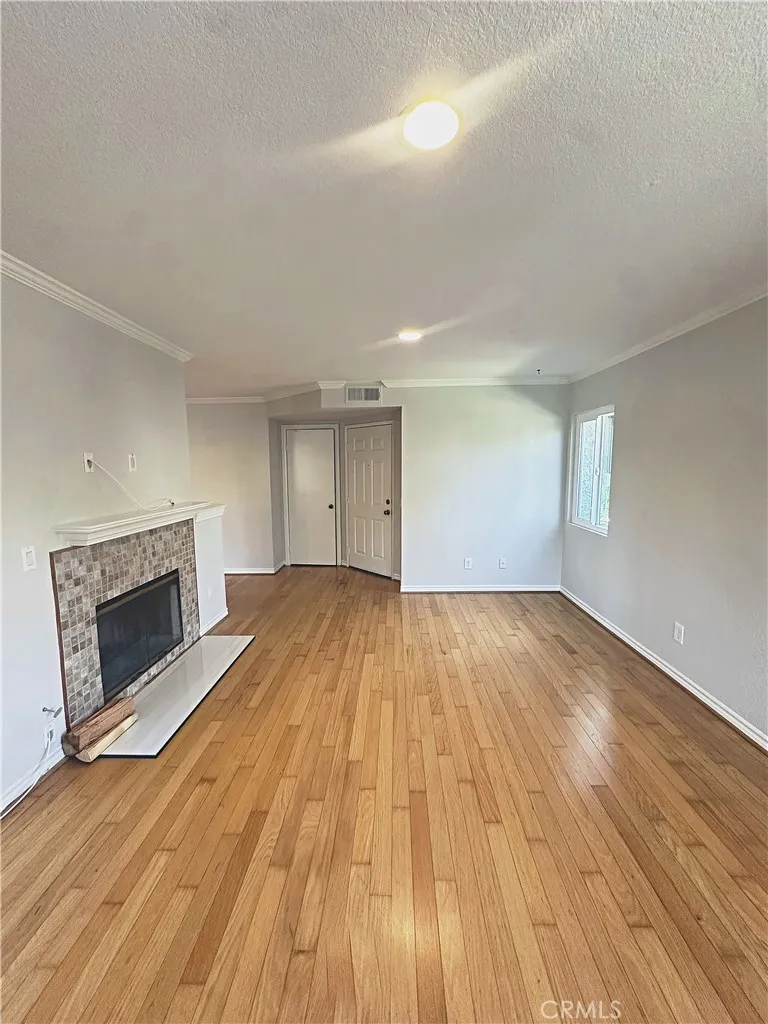Light and bright family room with real wood floors and newly refinished fireplace.