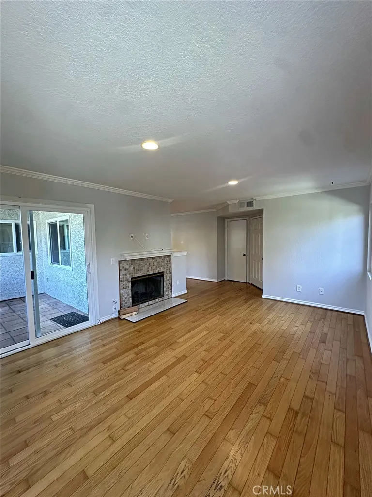 Light and bright family room with real wood floors and newly refinished fireplace.