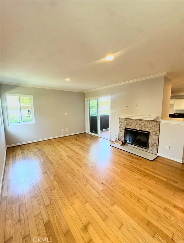 Light and bright family room with real wood floors and newly refinished fireplace.