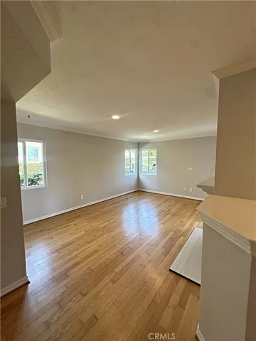 Light and bright family room with real wood floors and newly refinished fireplace.