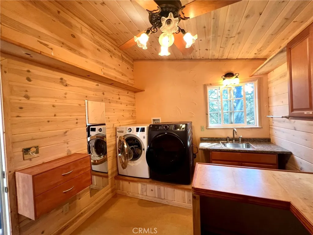 Spacious laundry room, a very utilitarian space, with a sink and lots of counter space, and drawers
