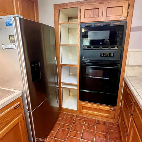 Large refrigerator, builtin gas range & microwave oven.