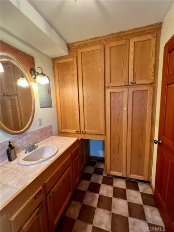 Lots of cabinetry for linen storage, brooms etc