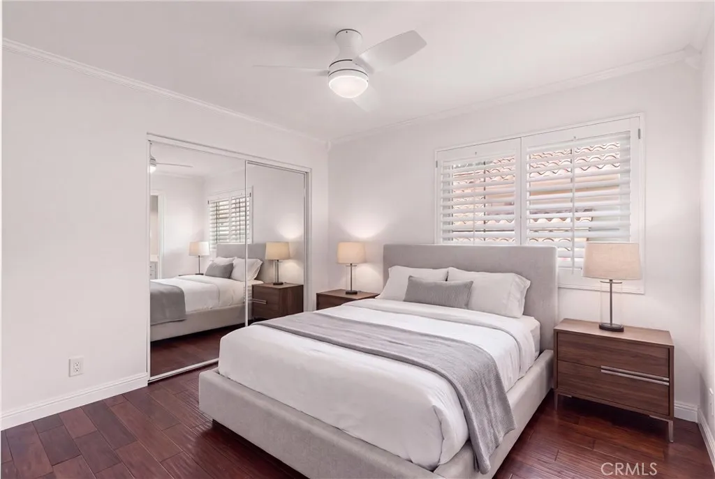 Secondary bedroom with mirror closet doors. Virtually staged bedroom.