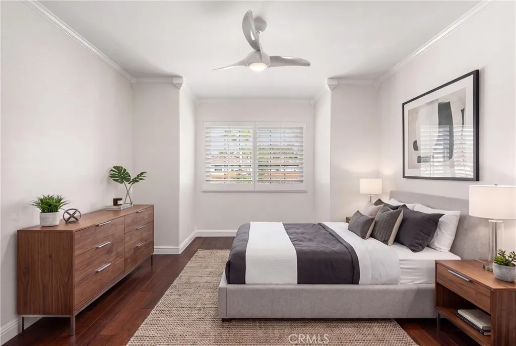 Hardwood flooring and ceiling fan. Virtually staged bedroom.