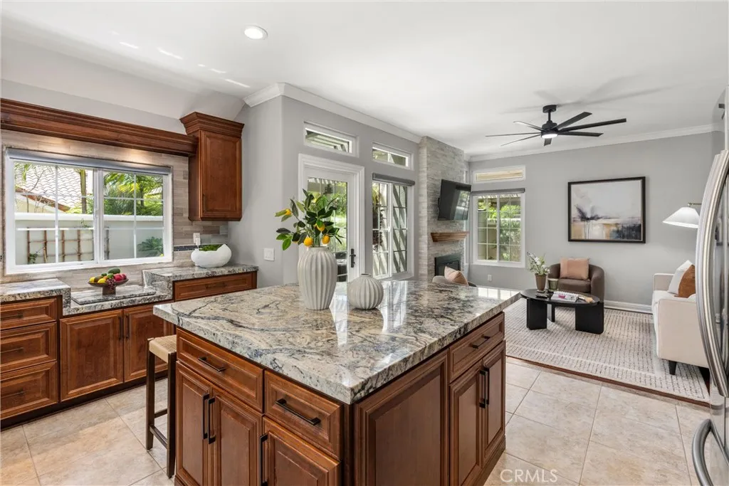 Open-concept kitchen and family room with large island, fireplace and abundant natural light.