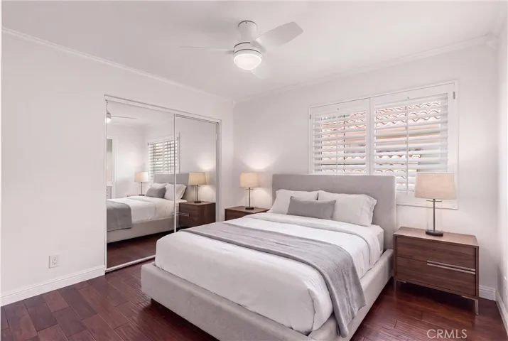 Secondary bedroom with mirror closet doors. Virtually staged bedroom.