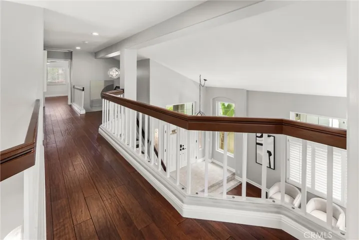 Spacious upstairs hallway with hardwood flooring and open views to the foyer below.