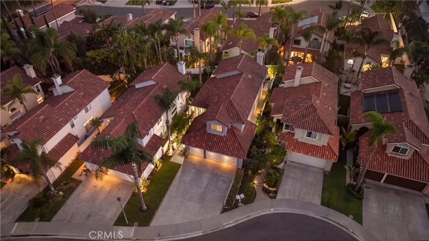 Aerial view showcasing the home within the beautifully landscaped community and surrounding hills.