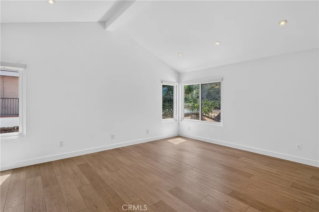 Primary suite featuring pitched ceilings and an abundance of natural light.