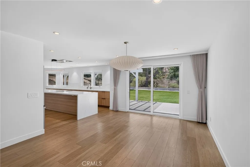Formal Dining Room with direct access to the kitchen and large windows providing natural light.
