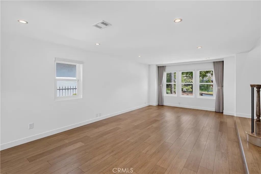 Formal living area featuring spacious design and natural lighting.