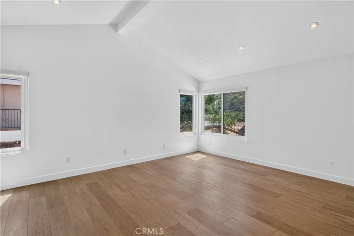 Primary suite featuring pitched ceilings and an abundance of natural light.
