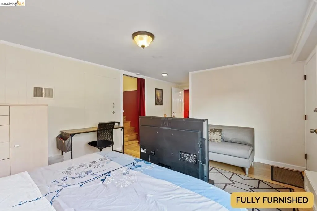 Bedroom 3 is downstairs and has an en suite full bathroom with shower.  Exterior door leads to the fully fenced backyard.  Room connects to the bonus space and laundry area, with double glass doors onto the backyard patio.
