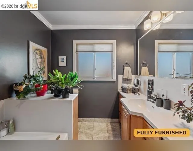 Bathroom featuring a Jacuzzi whirlpool tub, separate shower stall, vanity with an integrated sink, broad mirror, and a window with privacy blinds.