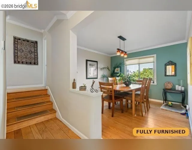 Hardwood flooring throughout, leading to a dining area. A few steps up the split level to the two upstairs bedrooms and full bathroom with Jacuzzi tub plus separate shower stall.