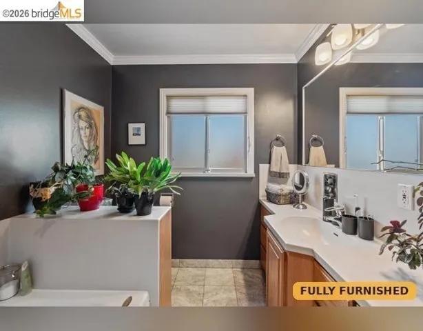 Bathroom featuring a Jacuzzi whirlpool tub, separate shower stall, vanity with an integrated sink, broad mirror, and a window with privacy blinds.