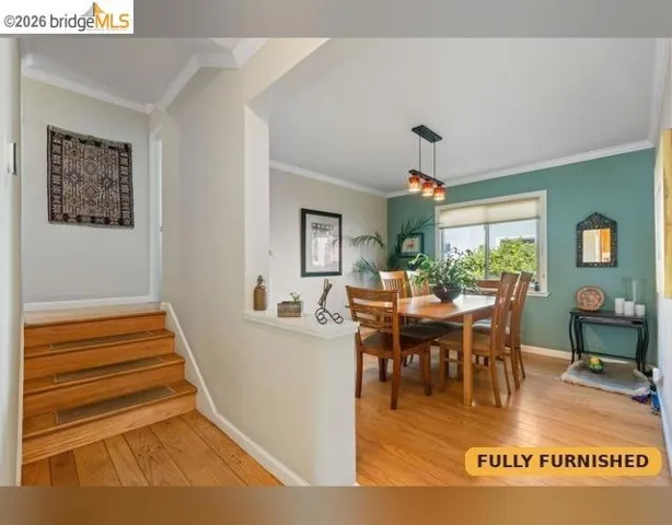 Hardwood flooring throughout, leading to a dining area. A few steps up the split level to the two upstairs bedrooms and full bathroom with Jacuzzi tub plus separate shower stall.
