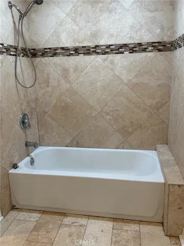 Primary full bath with travertine