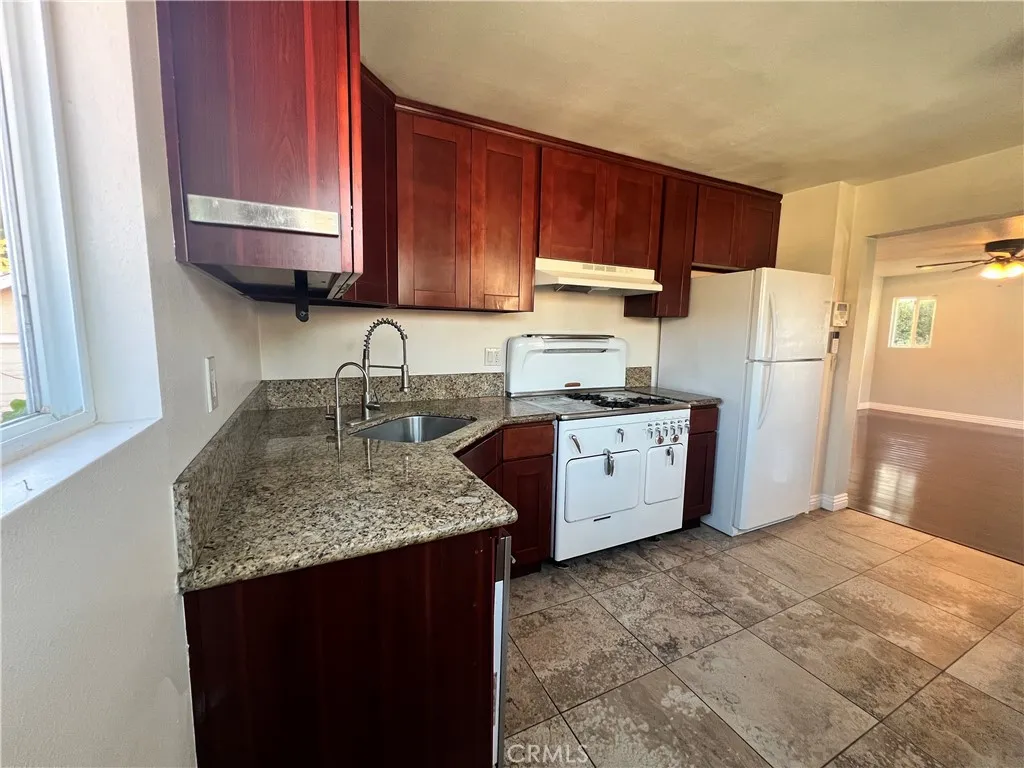 Kitchen showing the sink, stove, and refrigerator. Not depicted but included are the dishwasher and washer/dryer. Kitchen showing the sink, stove, and refrigerator. Not depicted but included are the dishwasher and washer/dryer.