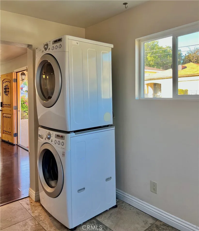 Washer/dryer in the kitchen. Door on the left is the home's front door. Washer/dryer in the kitchen. Door on the left is the home's front door.