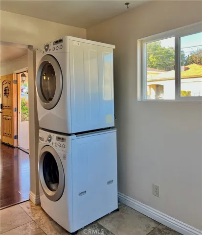 Washer/dryer in the kitchen. Door on the left is the home's front door.