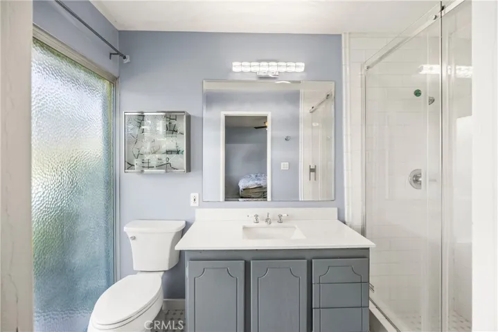 Primary Bathroom with Slider Access to the Backyard and a Pathway to the Pool.
