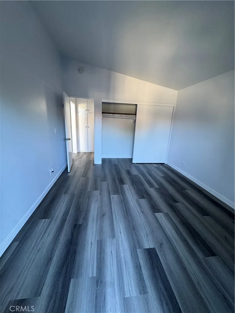 Spacious bedroom with window air conditioner and new engineered flooring Spacious bedroom with window air conditioner and new engineered flooring