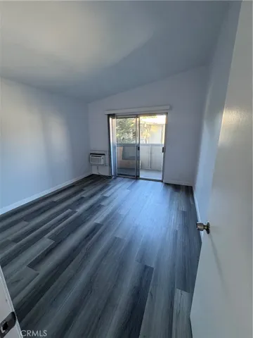 Bedroom with private balcony and window air conditioner