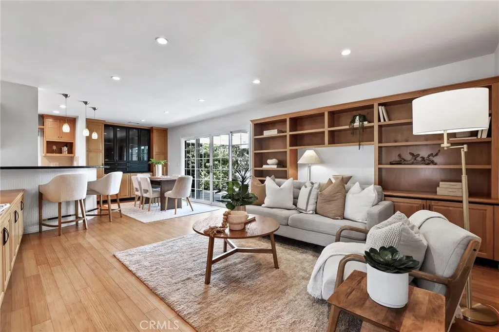 Living room with built-in bookcases and bamboo flooring throughout.
