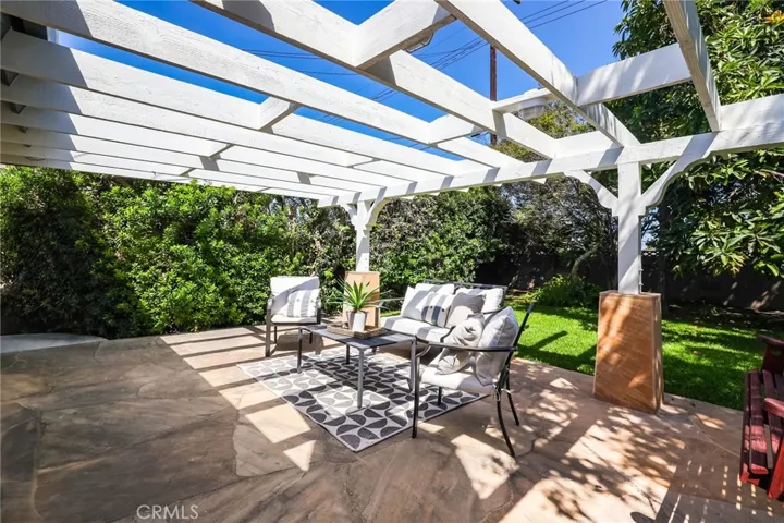 Pergola and built in swing add to the charm of this yard.