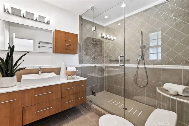 Updated Primary Bath with Large Walk-in Shower and custom sink and vanity.
