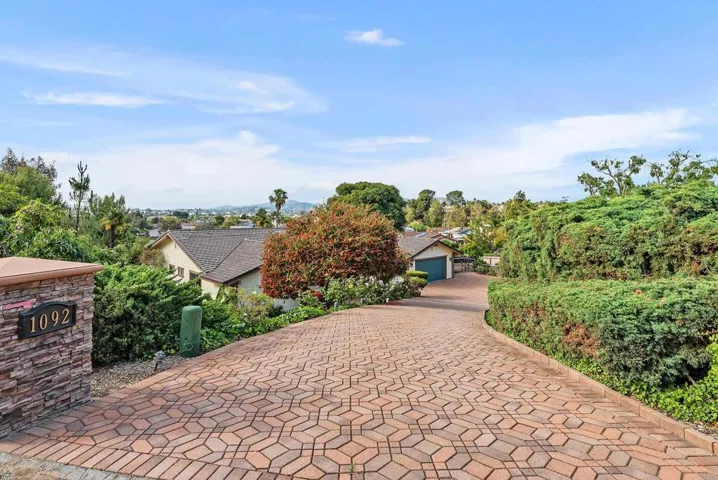 Private brick driveway leads to the front door.