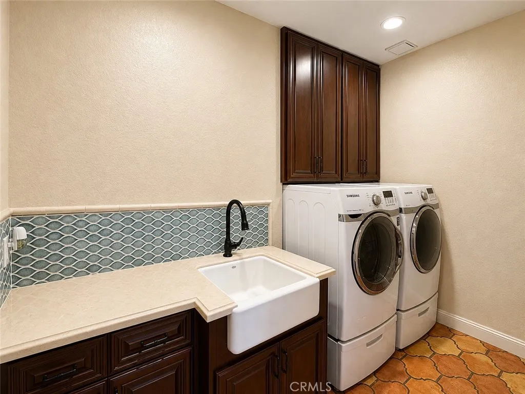 Inside, laundry room with washer, dryer, and plenty of storage
