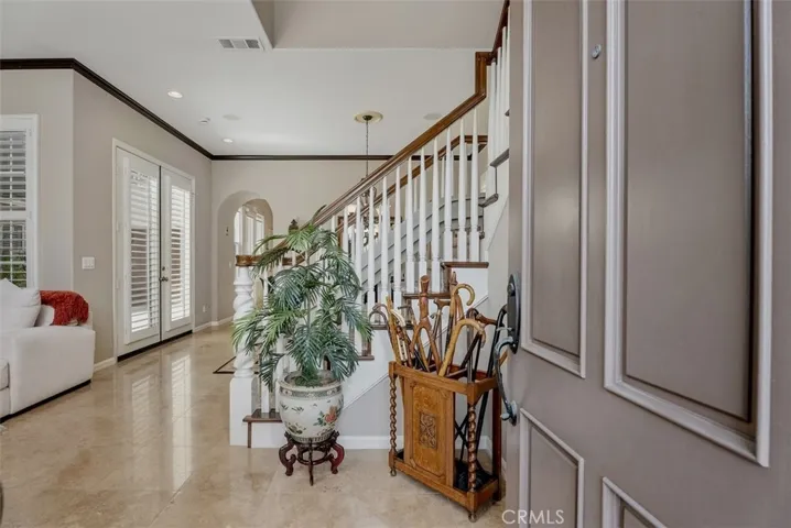 Welcoming entry to Travertine floors and Crown molding