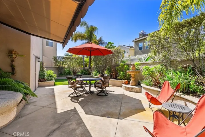 Relaxing low-maintenance back yard with electric retractable awning