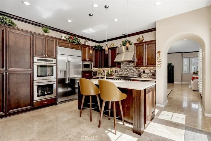 Stainless steel double oven, side-by-side Monogram refrigerator, and built-in microwave