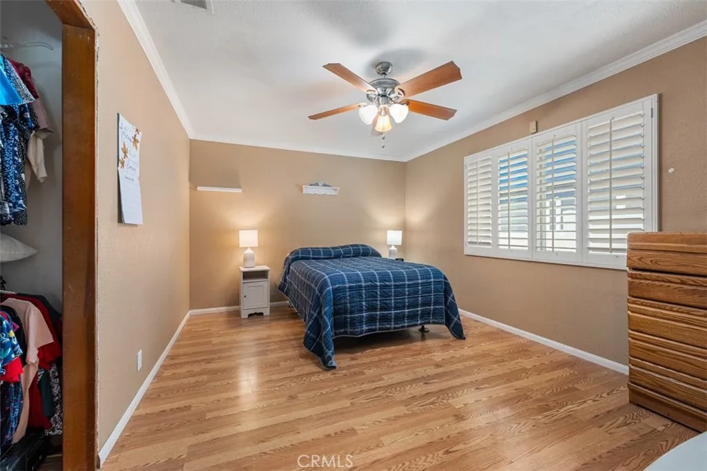 Hardwood floors, plantation shutters, ceiling fan, and dual PAYNE windows featured in bedroom #2 Hardwood floors, plantation shutters, ceiling fan, and dual PAYNE windows featured in bedroom #2