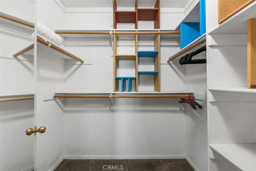 Primary Bedroom Walk-in Closet Primary Bedroom Walk-in Closet
