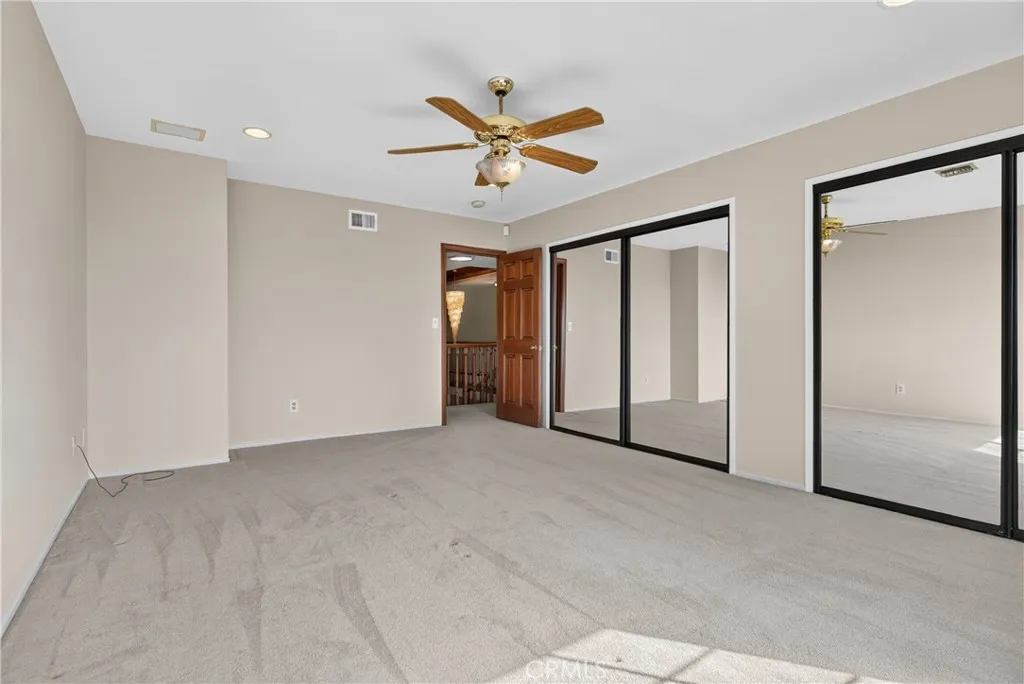 Another angle of Upstairs bedroom 2 with double mirrored closets