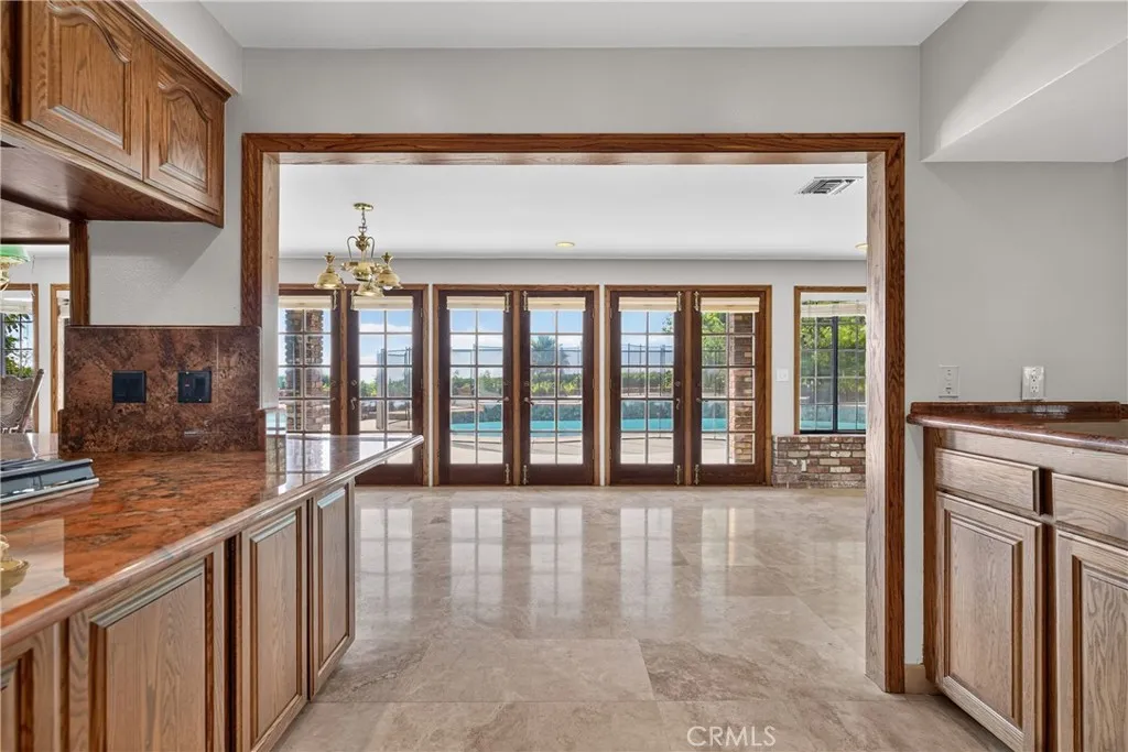 Kitchen with views to the backyard, pool, and open view