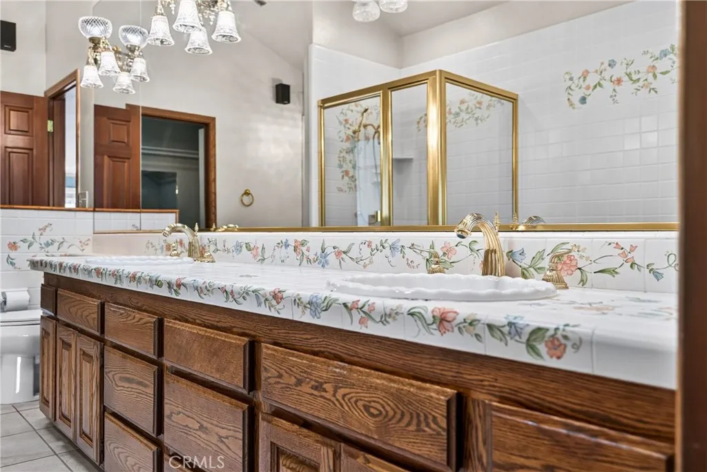 Primary Ensuite Bathroom with dual sinks, vanity area, soaking tub, shower, walk in closet- artisan tilework