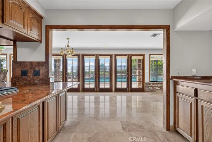 Kitchen with views to the backyard, pool, and open view