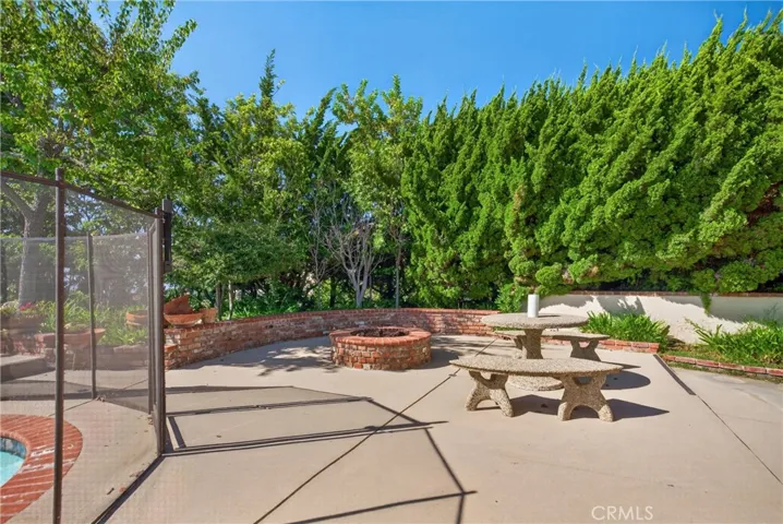 additional view of backyard with sitting area and firepit